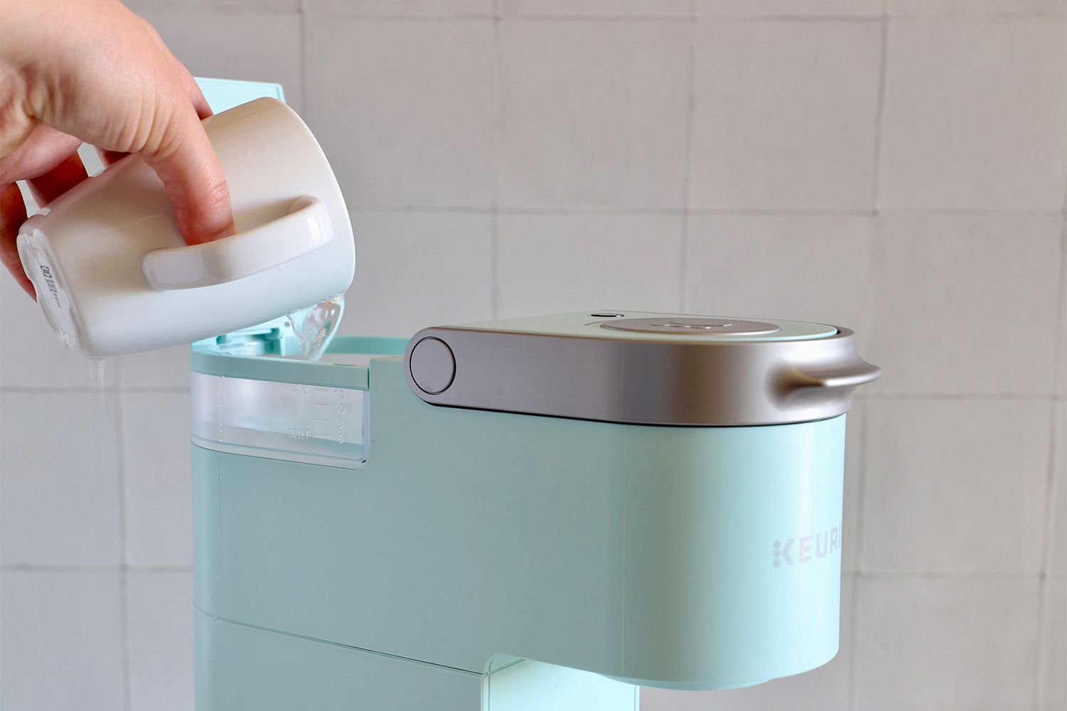 Keurig coffee machines k mini single on counter being used by person 