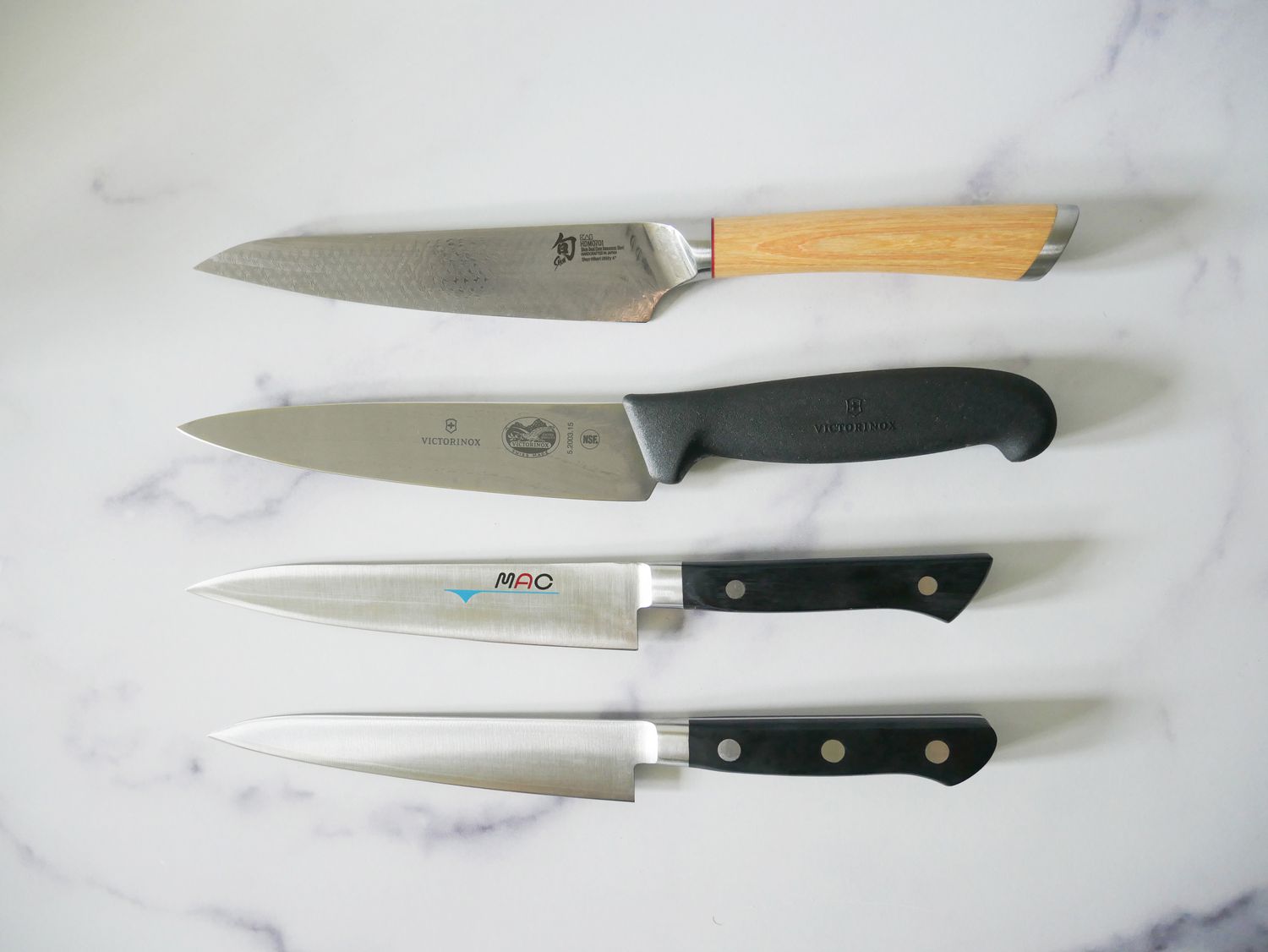 our favorite knives on a marble countertop