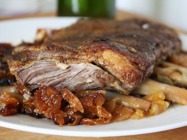 Close-up view of braised lamb ribs on a serving plate. 
