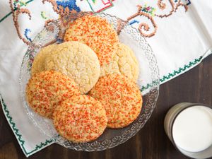 Overhead of a plate of soft and chewy sugar cookies on a glass plate
