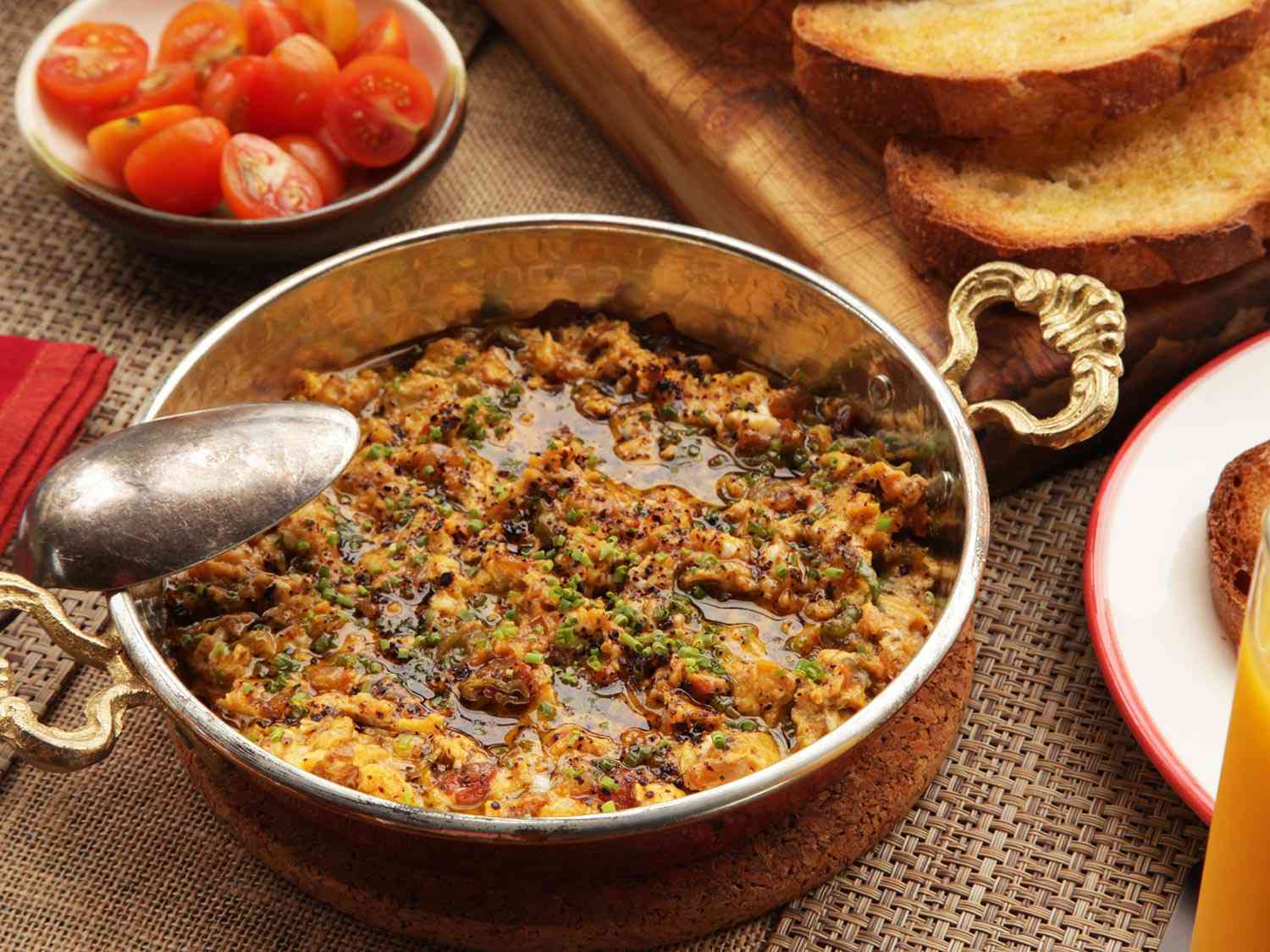 Menemen finished with chopped chives in sahan