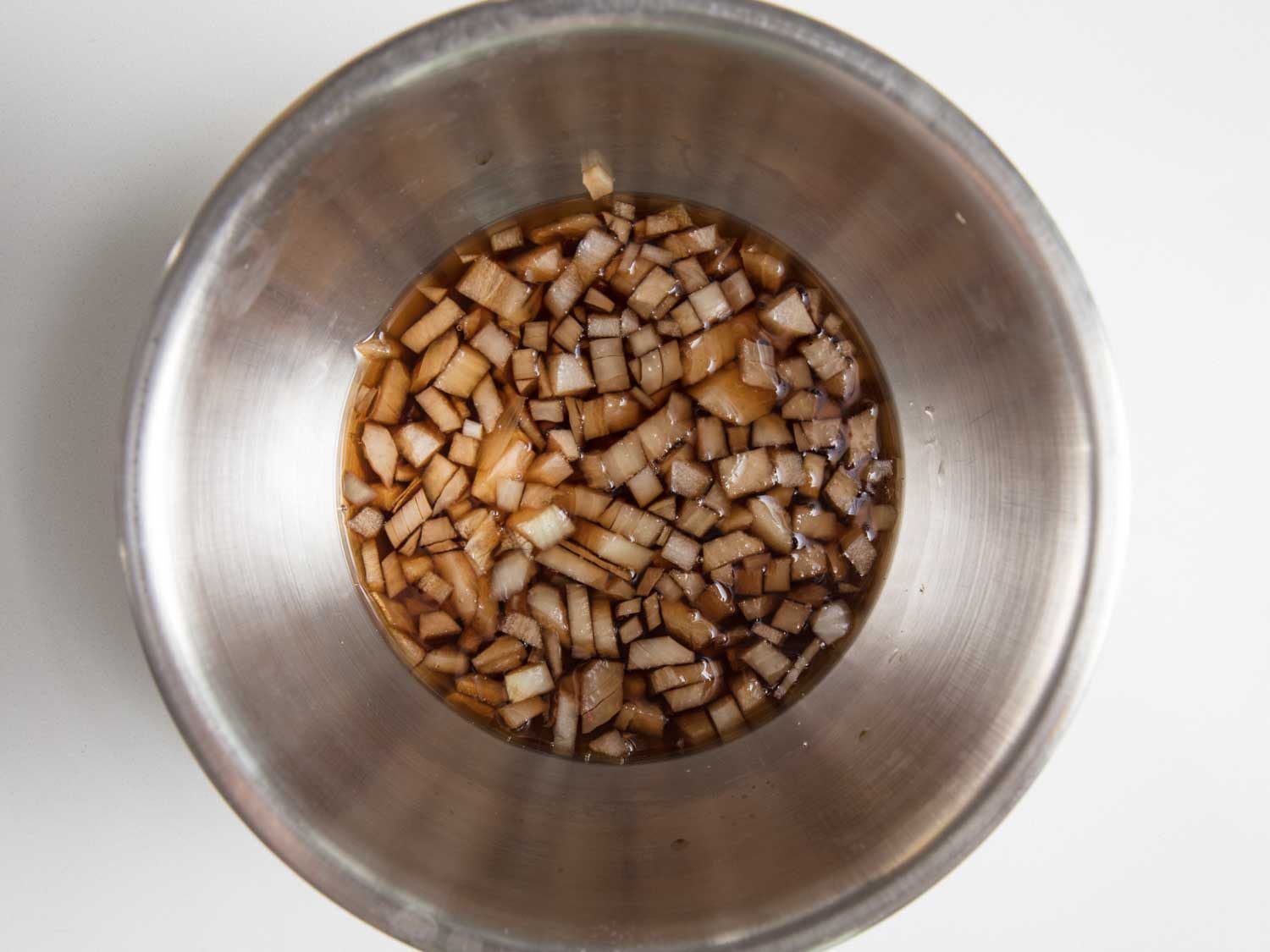 Quick-pickling diced onion in sherry vinegar.