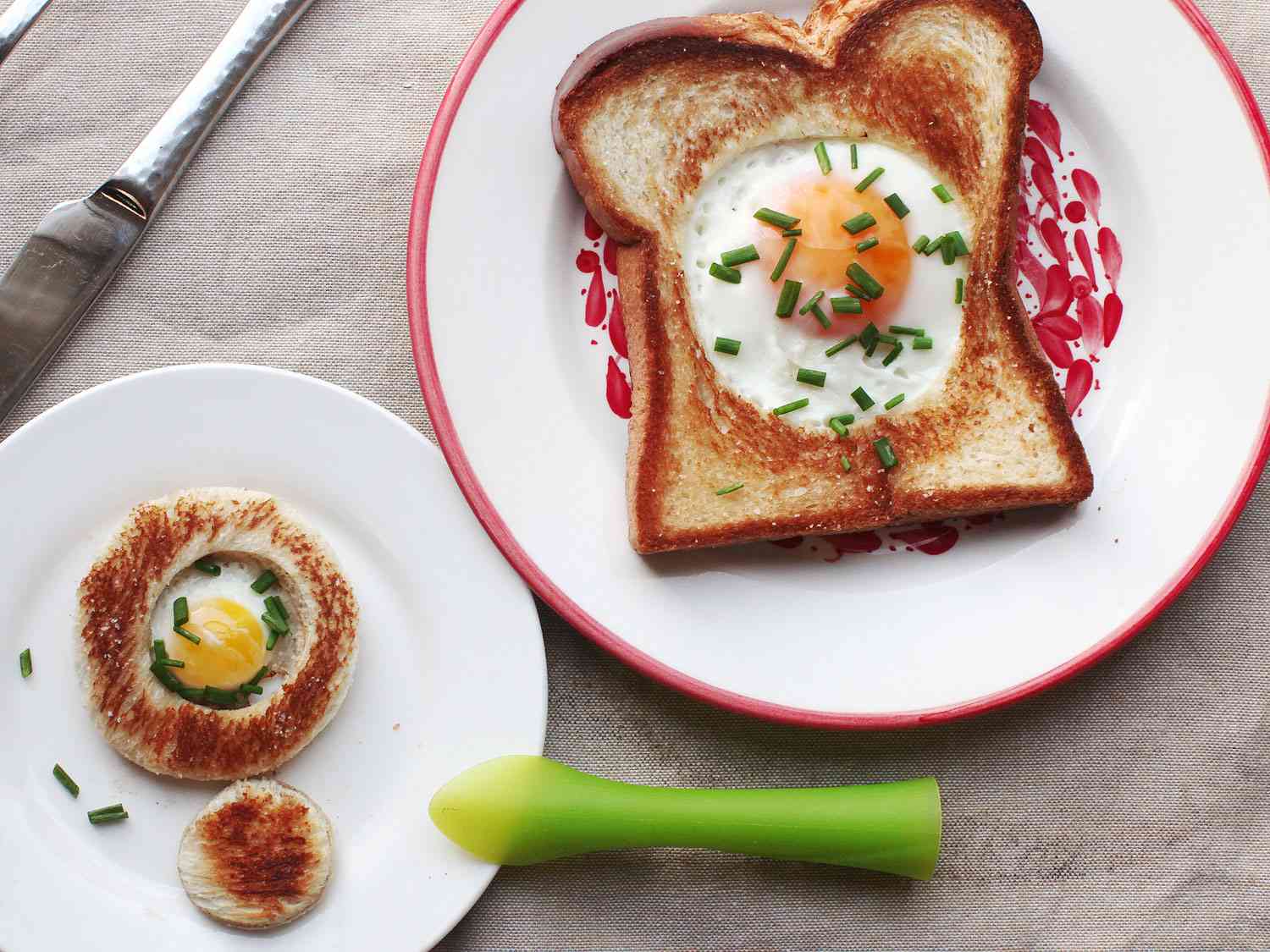 A full-size and tiny version of egg-in-a-hole plated side by side.