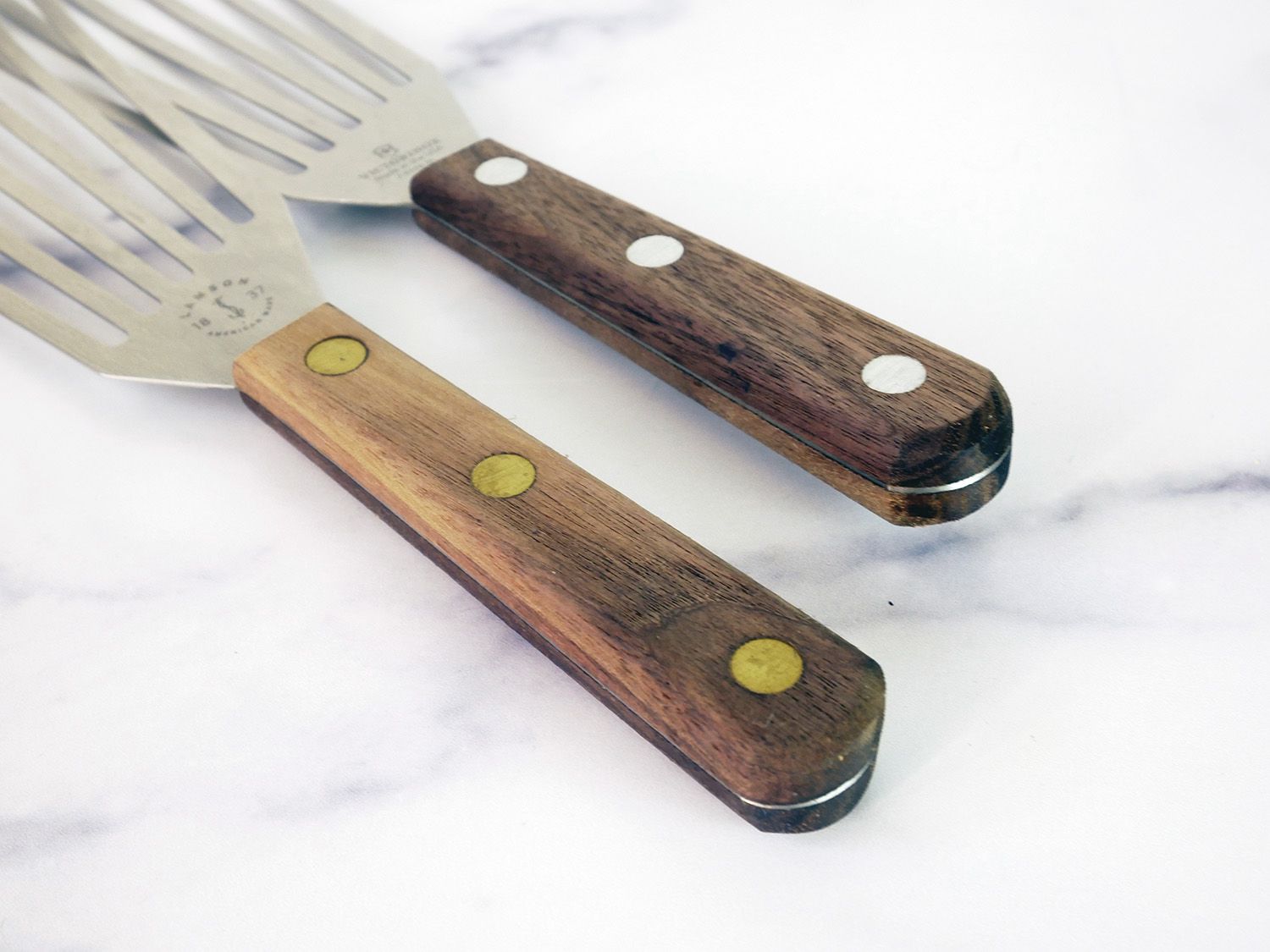 a closeup of the rough wooden handles on the Lamson and Victorinox spatulas