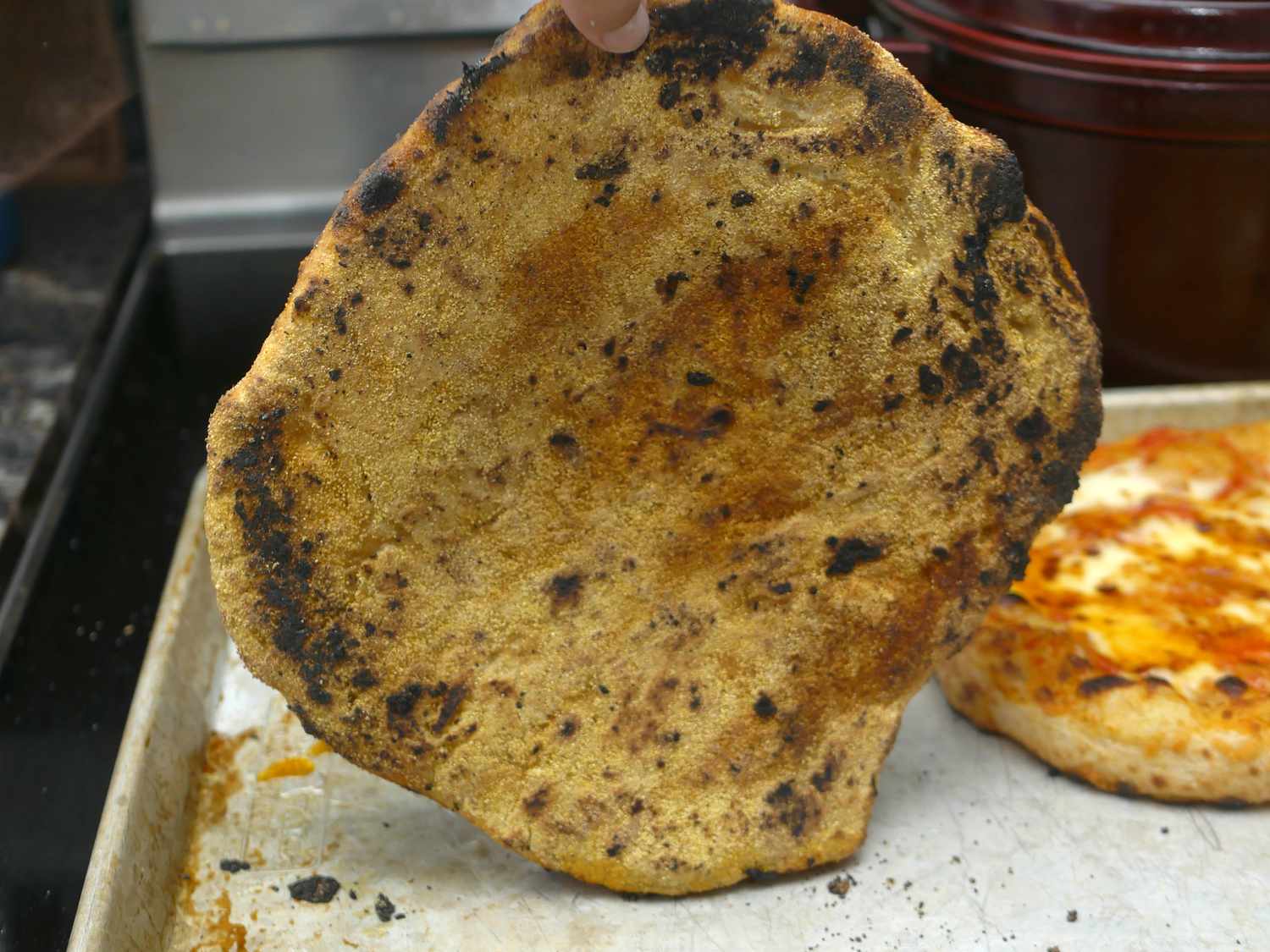 the underside of a pizza cooked on the Gozney arc that showcases the leopard spotting. 