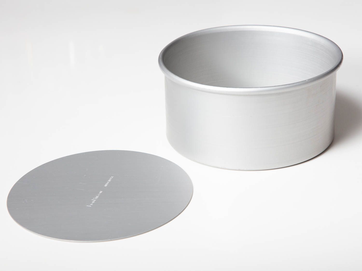 An empty aluminum cheesecake pan which was designed and manufactured specifically for this recipe.