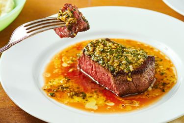 Steak DeBurgo dish on a plate with a piece held on a fork