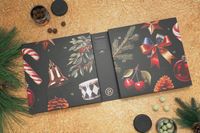 The Lakrids by Bülow Holiday Advent Calendar laid open next to some Christmas tree branches