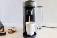 The Nespresso VertuoPlus Coffee and Espresso Machine by De'Longhi dispensing coffee into a mug