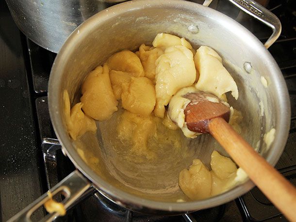 Dough placed back in a pan and continually stirred with a wooden spatula. 