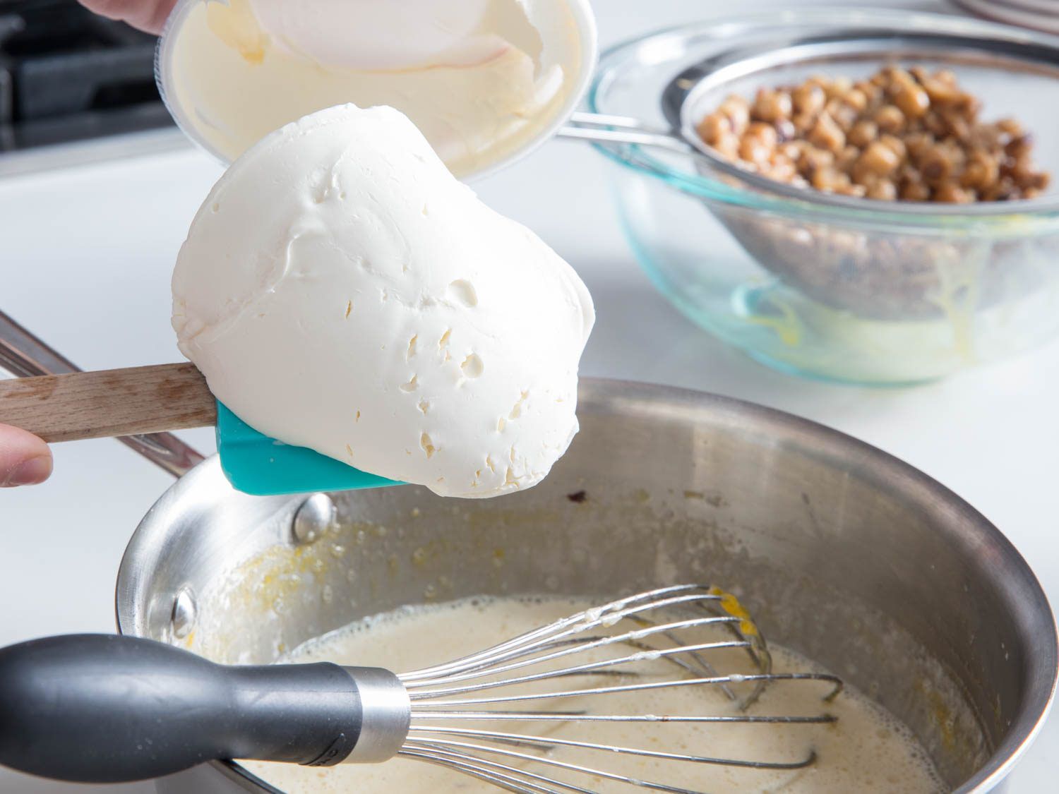 Adding mascarpone to the hazelnut ice cream base.