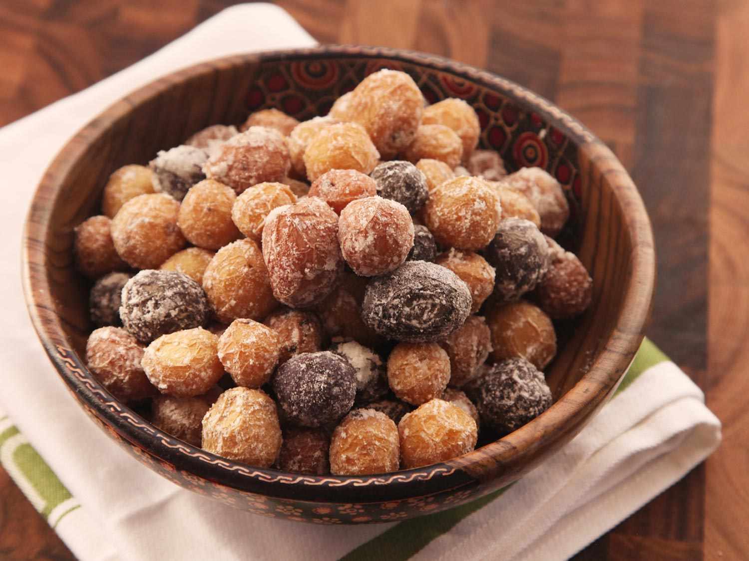 Wooden serving bowl of salt-crusted assorted new potatoes