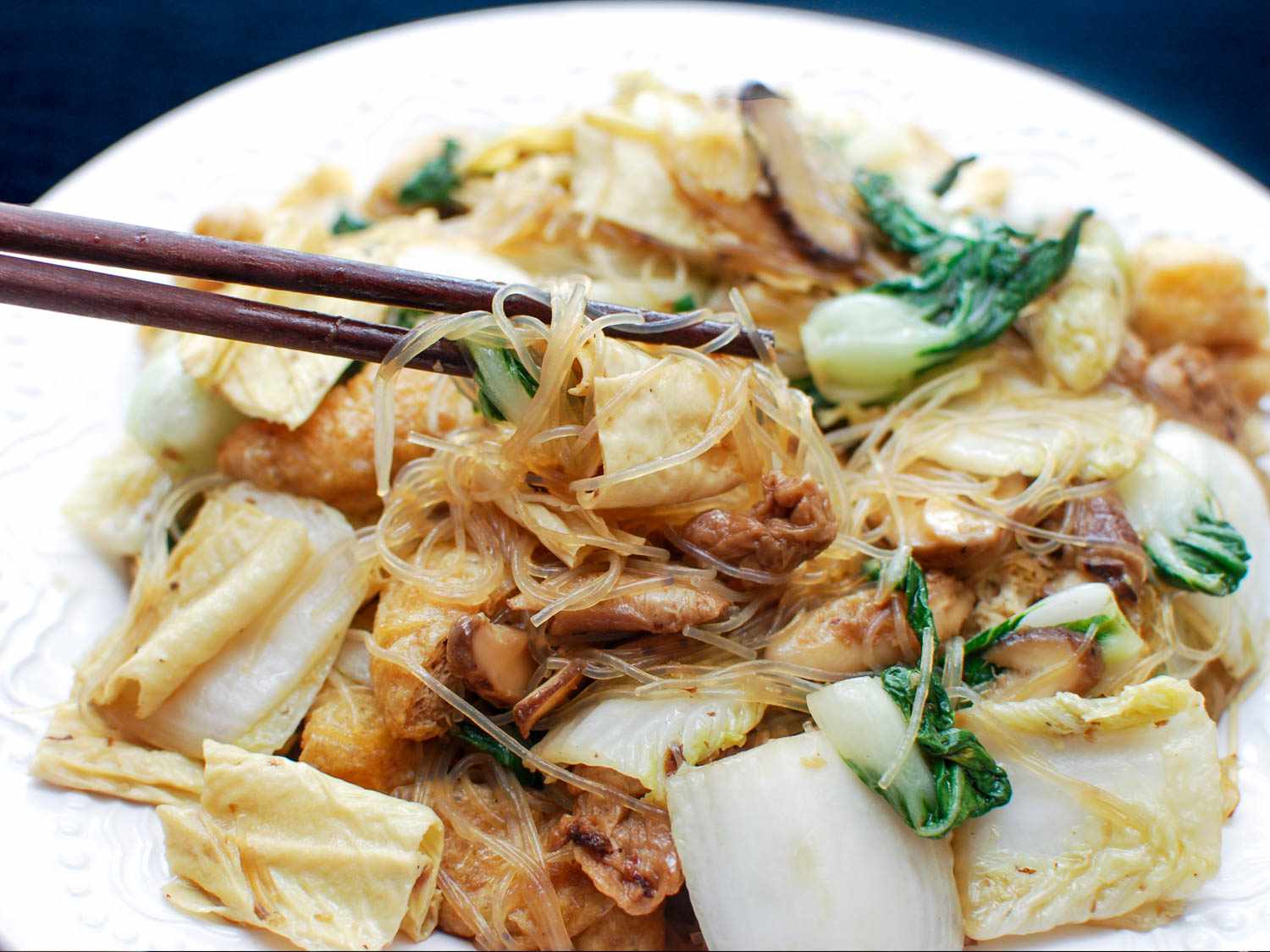 Using chopsticks to enjoy the Buddha's Delight.