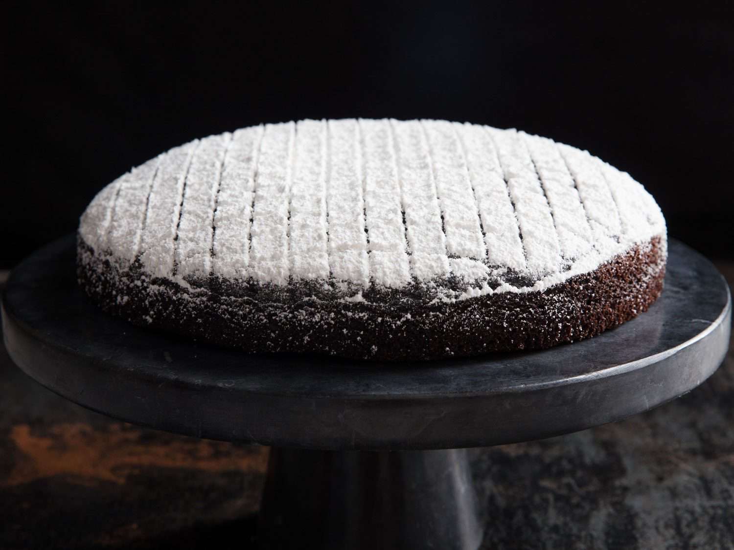 Dairy-free chocolate cake dusted with powdered sugar.