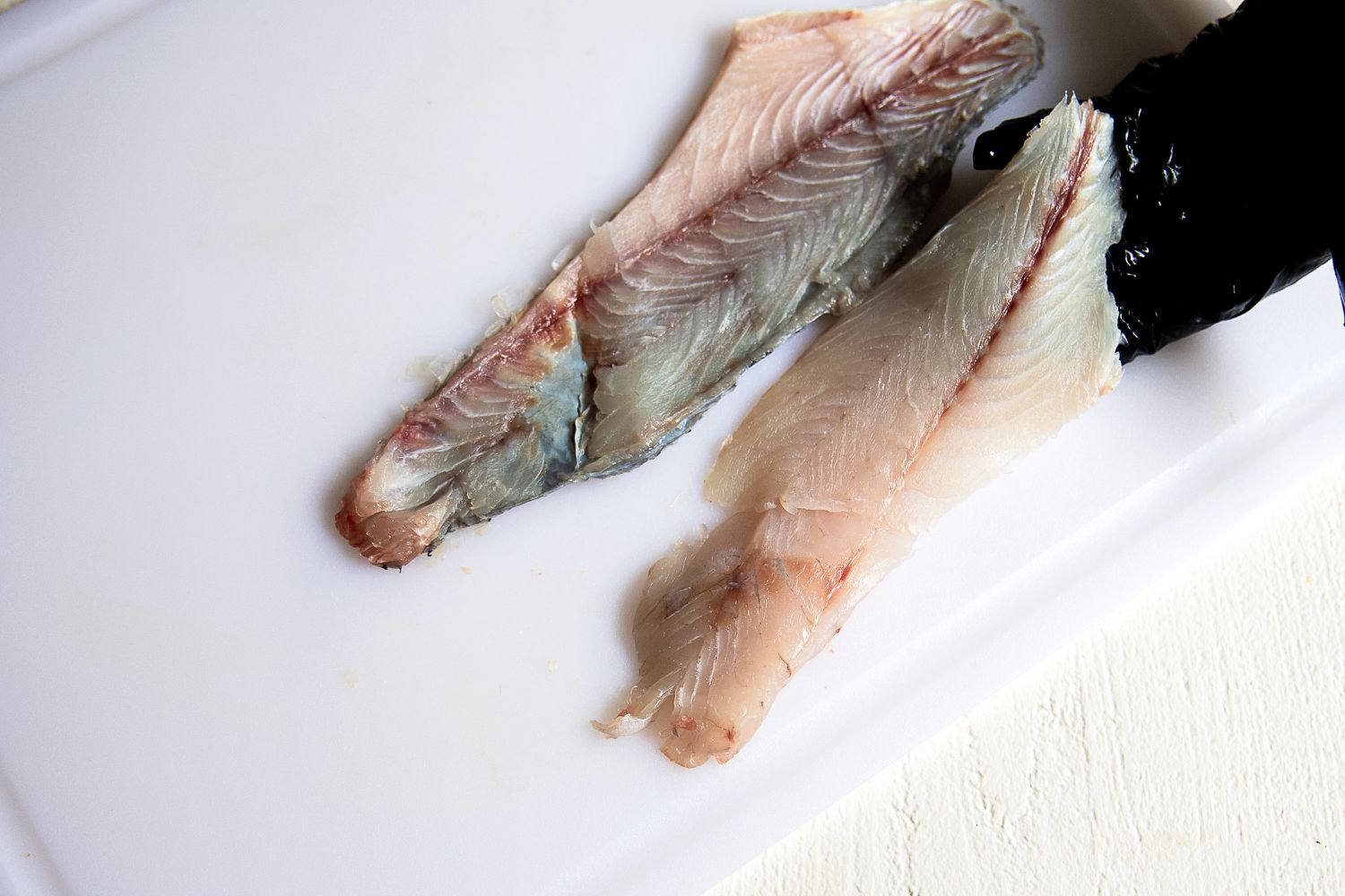 A person using the Victorinox Fillet Knife to slice a fish