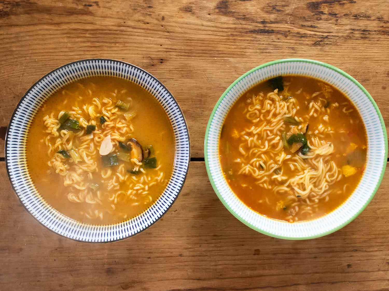 Prepared Shin Ramyun Black in bowls side by side, with the Korean version on the right.