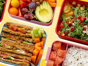 An assortment of lunchboxes with sandwiches fruits vegetables and sushi options