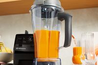 Vitamix 5200 Professional-Grade Blender filled with orange smoothie