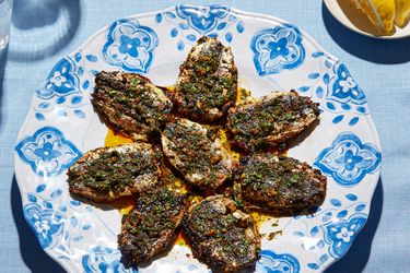 Cooked chermoula sardines arranged on a decorative plate with a garnish