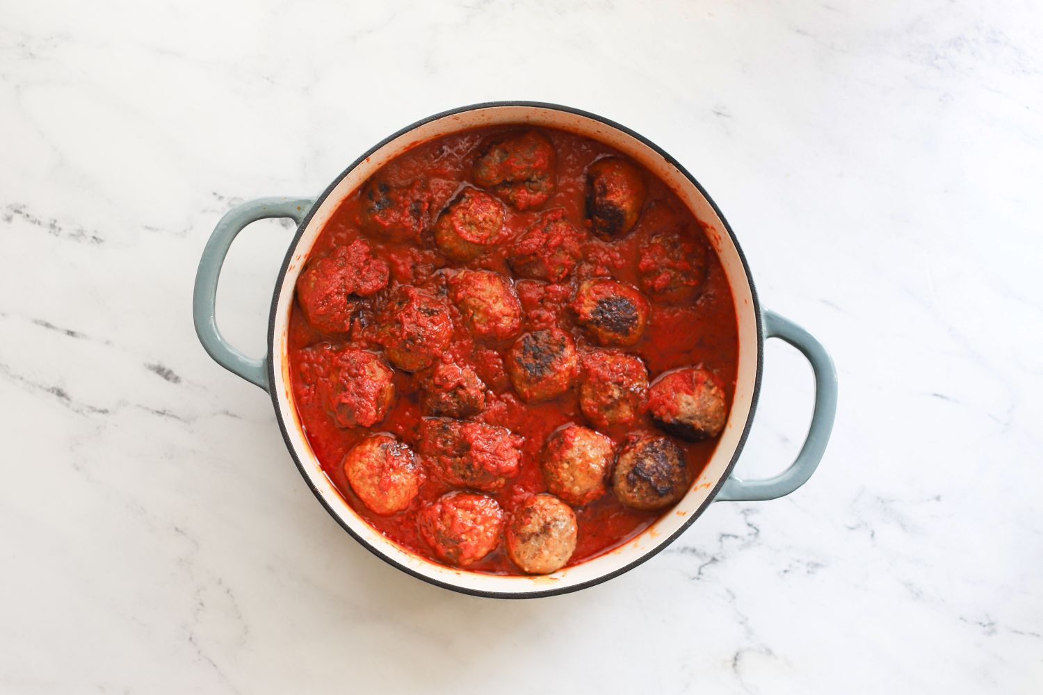 A pot filled with meatballs in tomato sauce