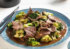 Plate of Stir-Fried Beef with Broccoli in Oyster Sauce with chopsticks resting on the edge