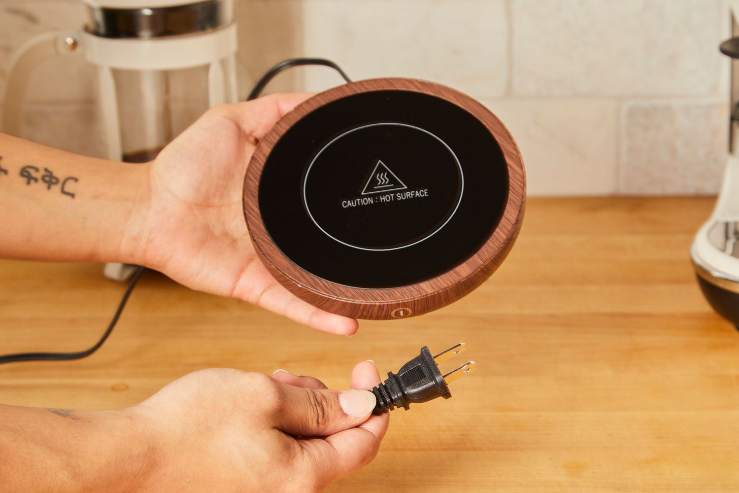 Person holding Sweetful Coffee Mug Warmer