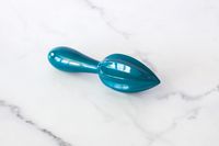 A blue ZAK! Handheld Citrus Reamer on a white counter.