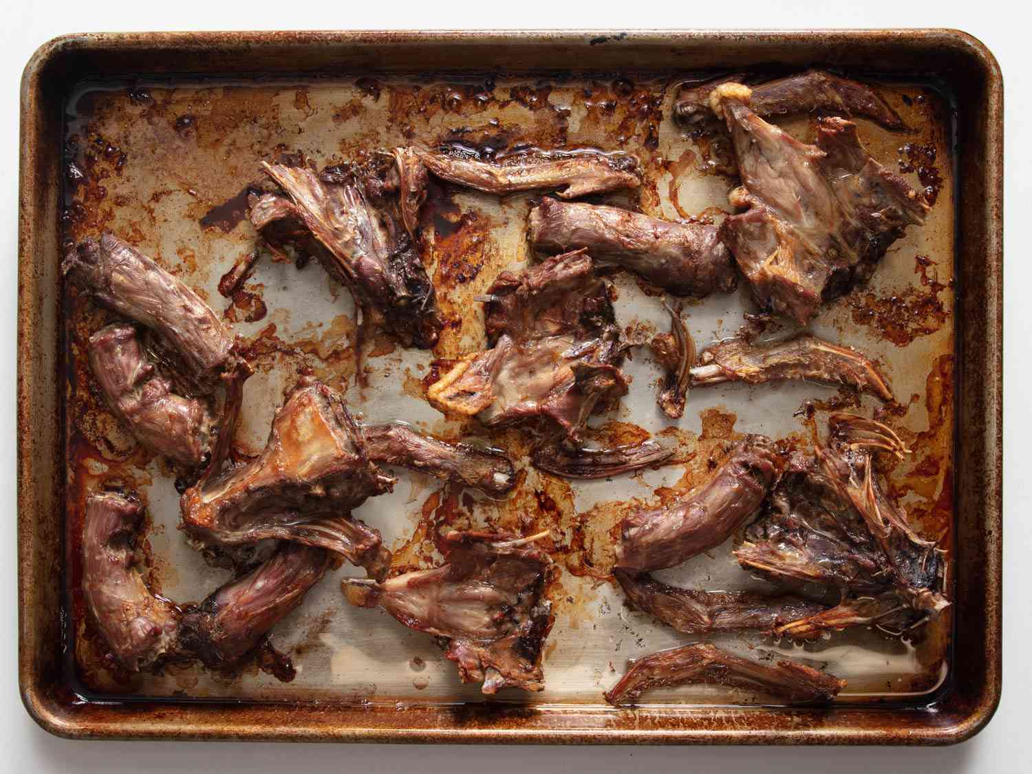Roasted duck bones on a baking tray. 