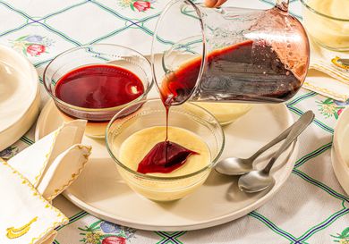 Side view of pouring syrup onto puddings 