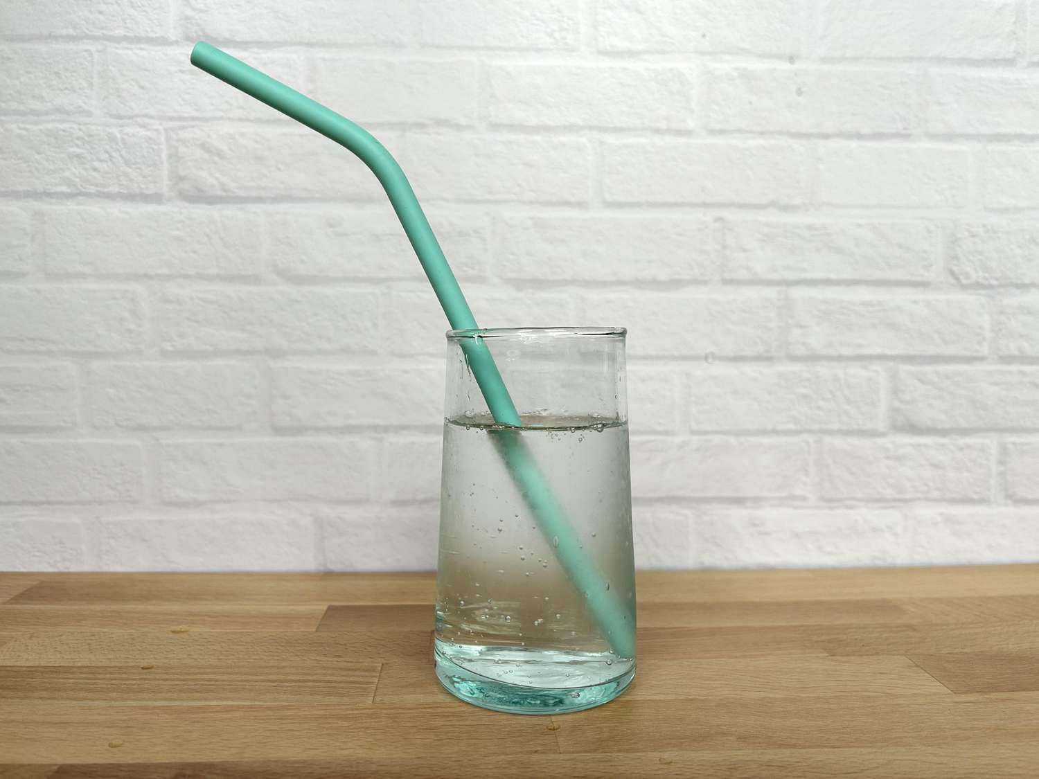 A silicone straw in a glass of sparkling water
