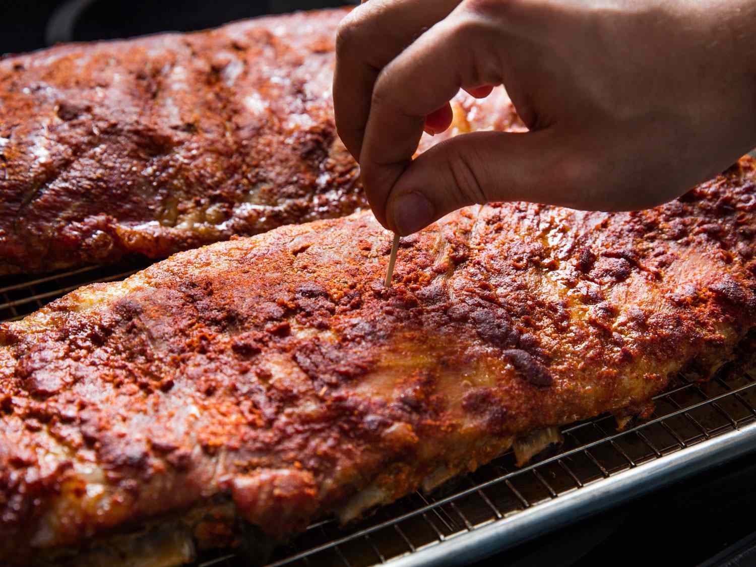 Testing for doneness of ribs with a toothpick