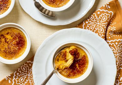 Pumpkin crme brle served in small ramekins with a spoon and napkin