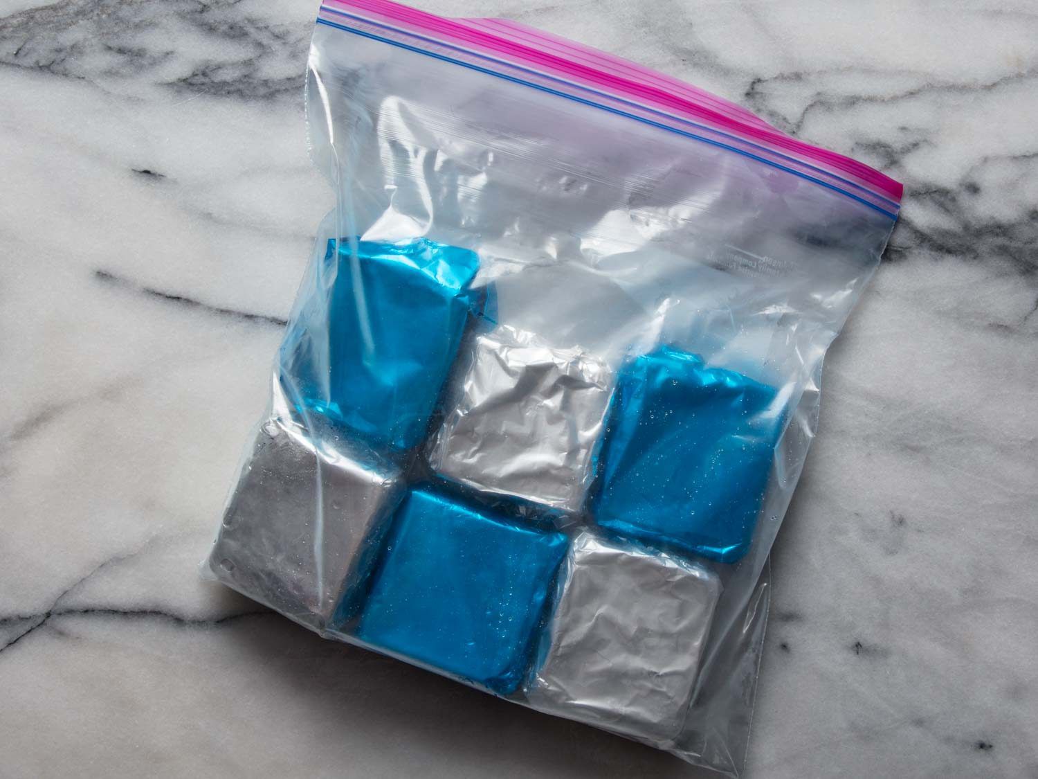 A bag of homemade Klondike Bars wrapped in silver and blue foil.