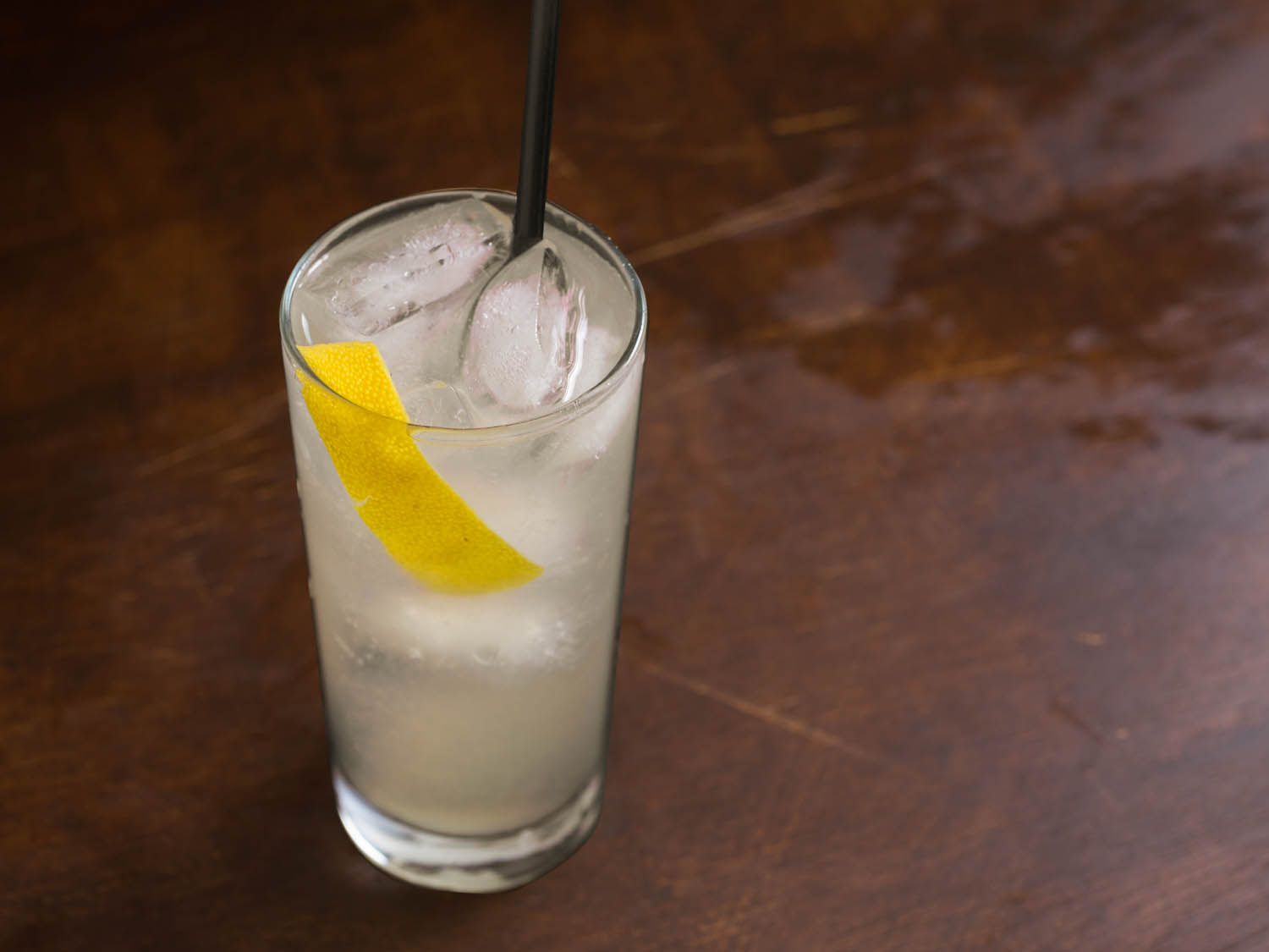 Tom Collins over ice garnished with lemon peel