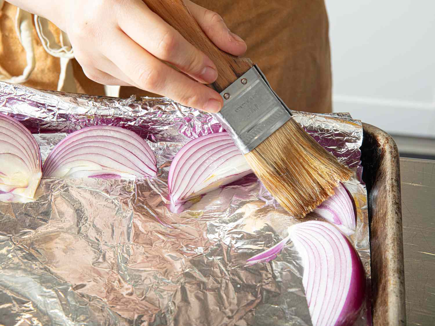 Brushing onions with oil