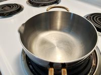 A closeup of the pour spout and interior of the Great Jones Little Saucy saucier