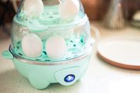 Hard boiled eggs cooking in the Dash egg cooker