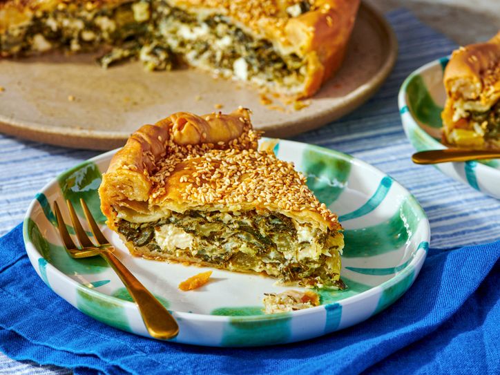 A slice of homemade phyllo dough pie on a plate with a fork