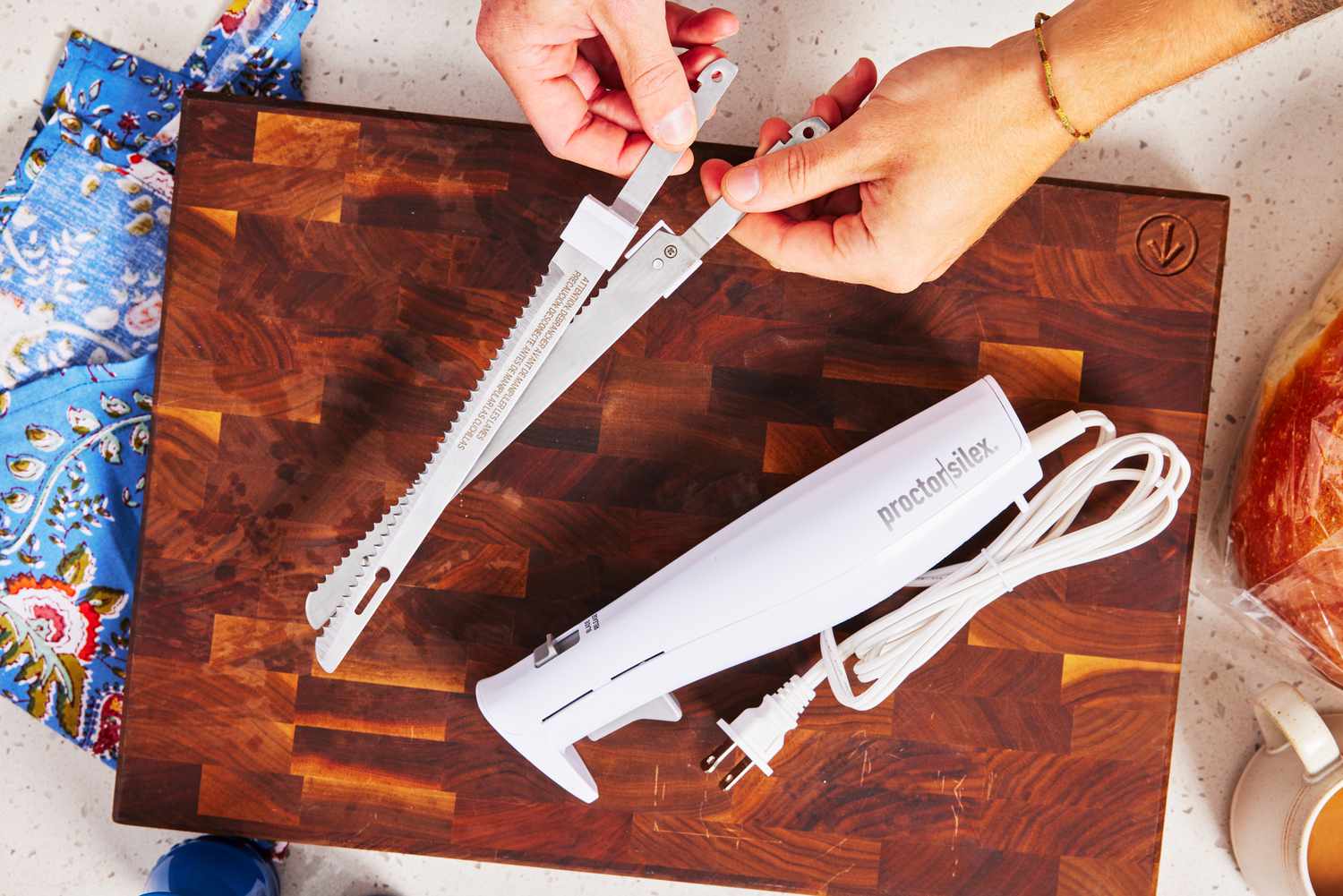 a person holding two blades from an electric knife