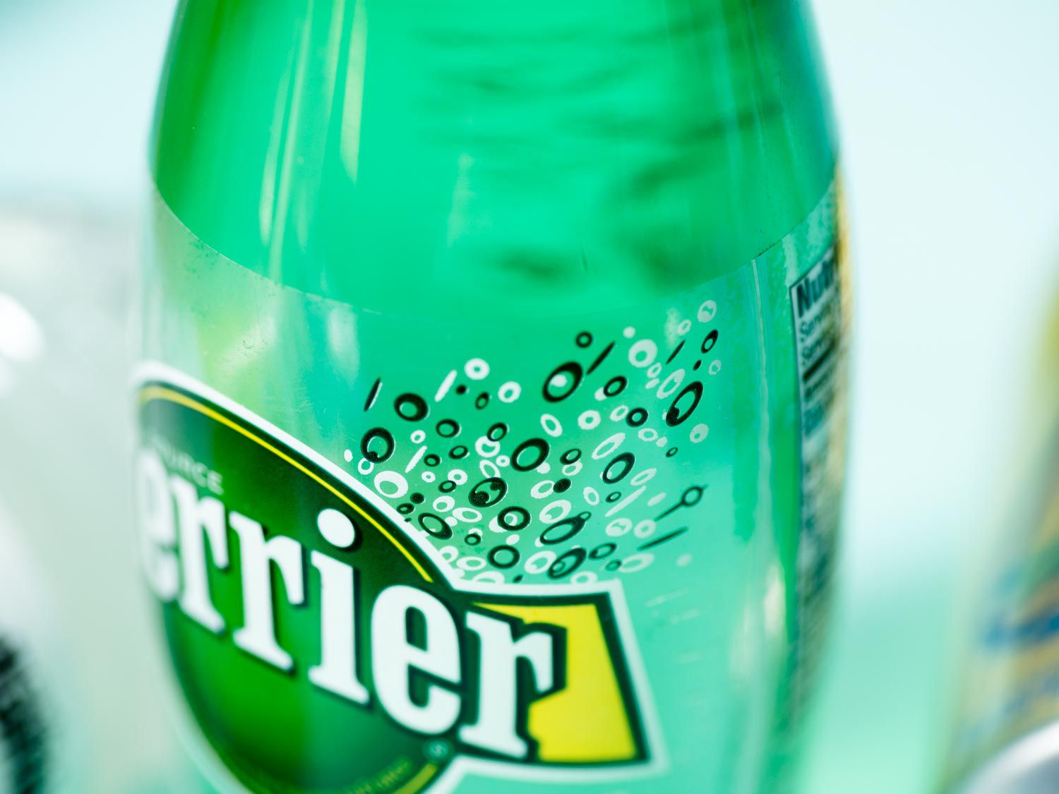 Close-up of a green bottle of Perrier sparkling water.