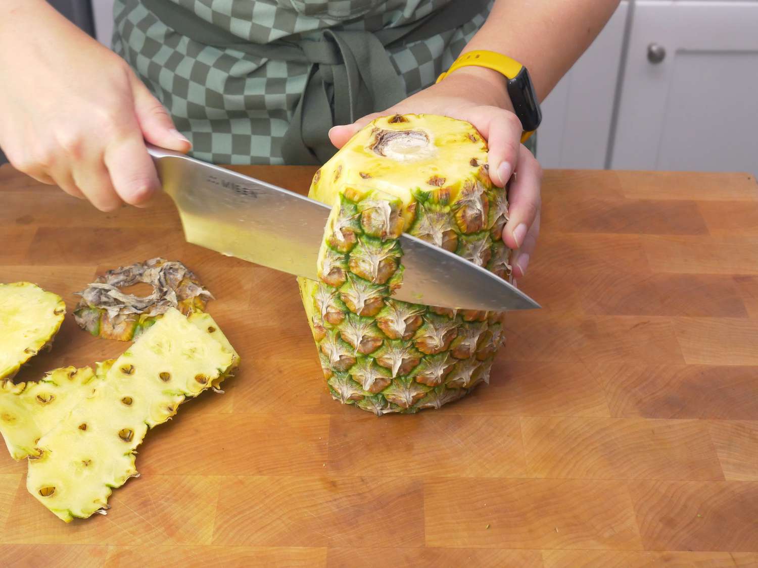 peeling the skin off a pineapple with the Misen chef knife