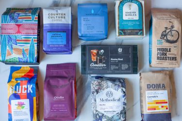 A number of coffee bags on a kitchen countertop.