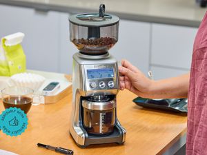 A person adjusting the dial of the Breville Smart Grinder Pro.