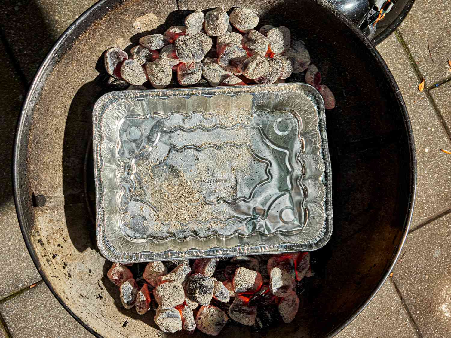 Overhead view of pan in charcoal grill