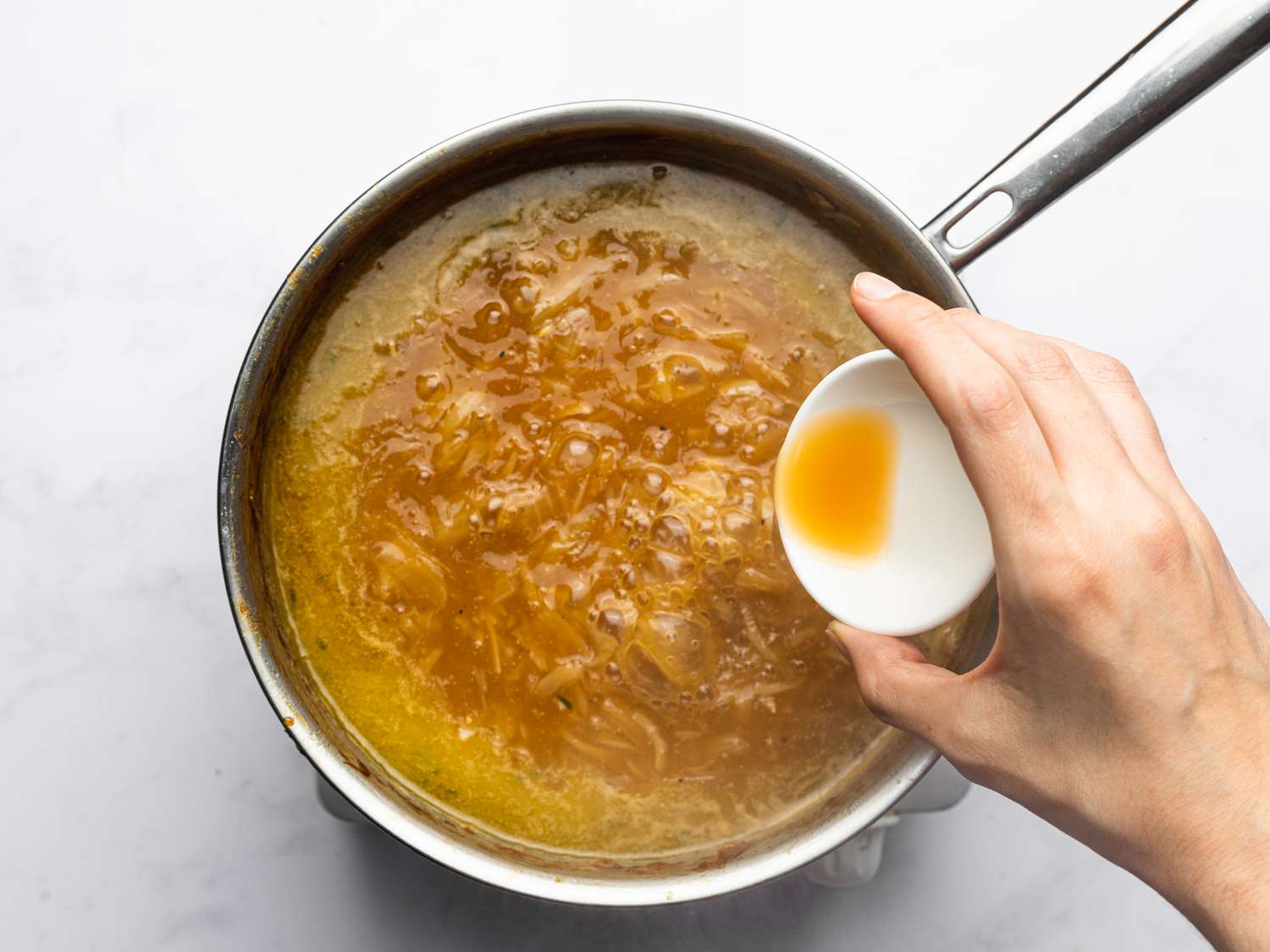 Overhead view of adding to soup