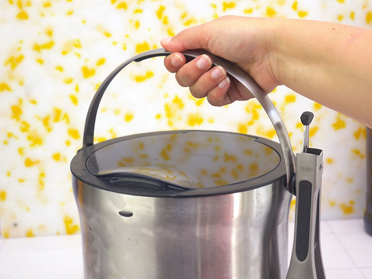 a person lifting the handle on the ice bucket
