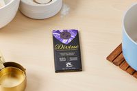 A Divine extra-dark chocolate bar on a kitchen countertop.