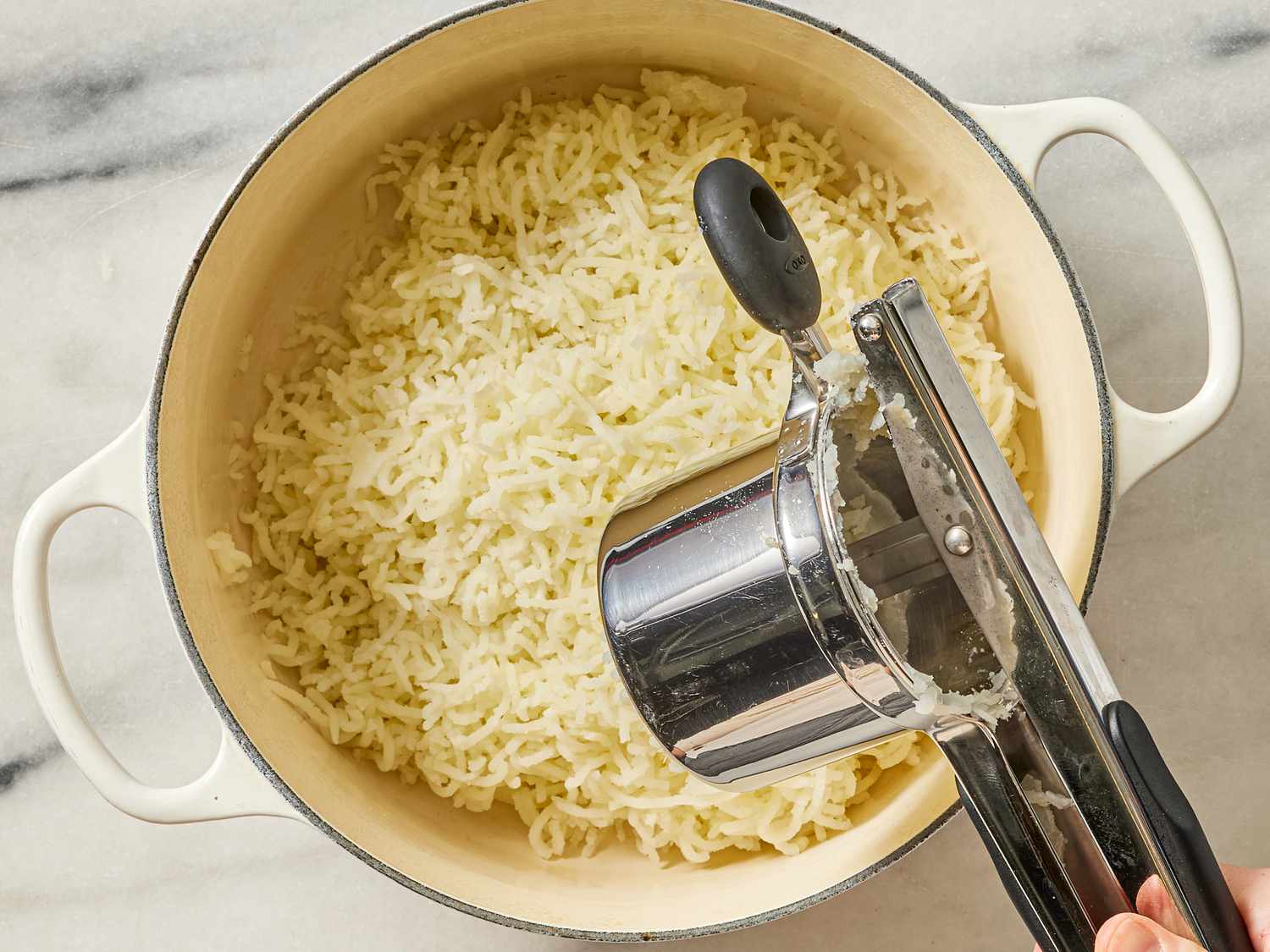 Overhead view of ricing potatoes
