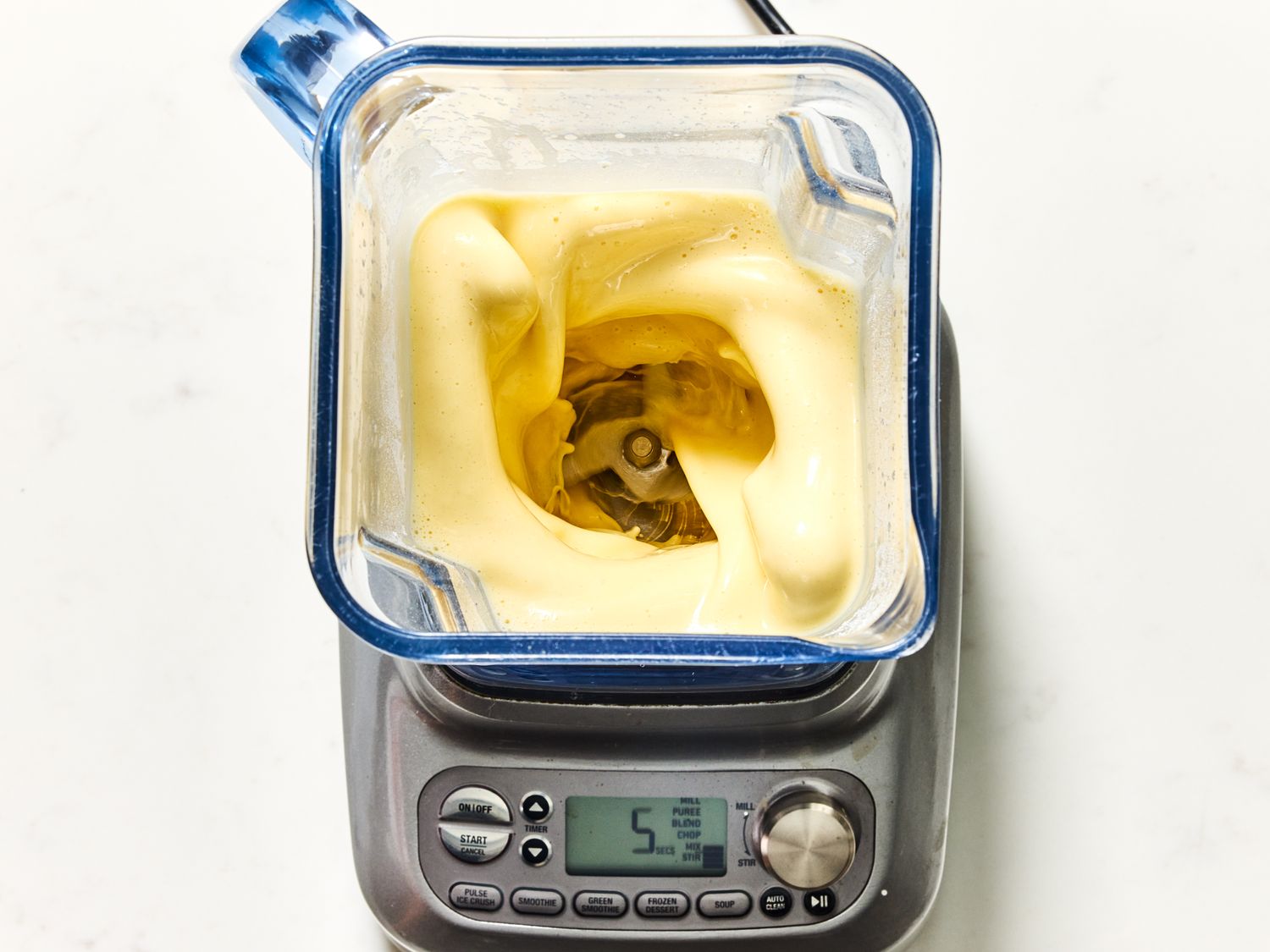 Blended batter in a blender on a digital kitchen scale