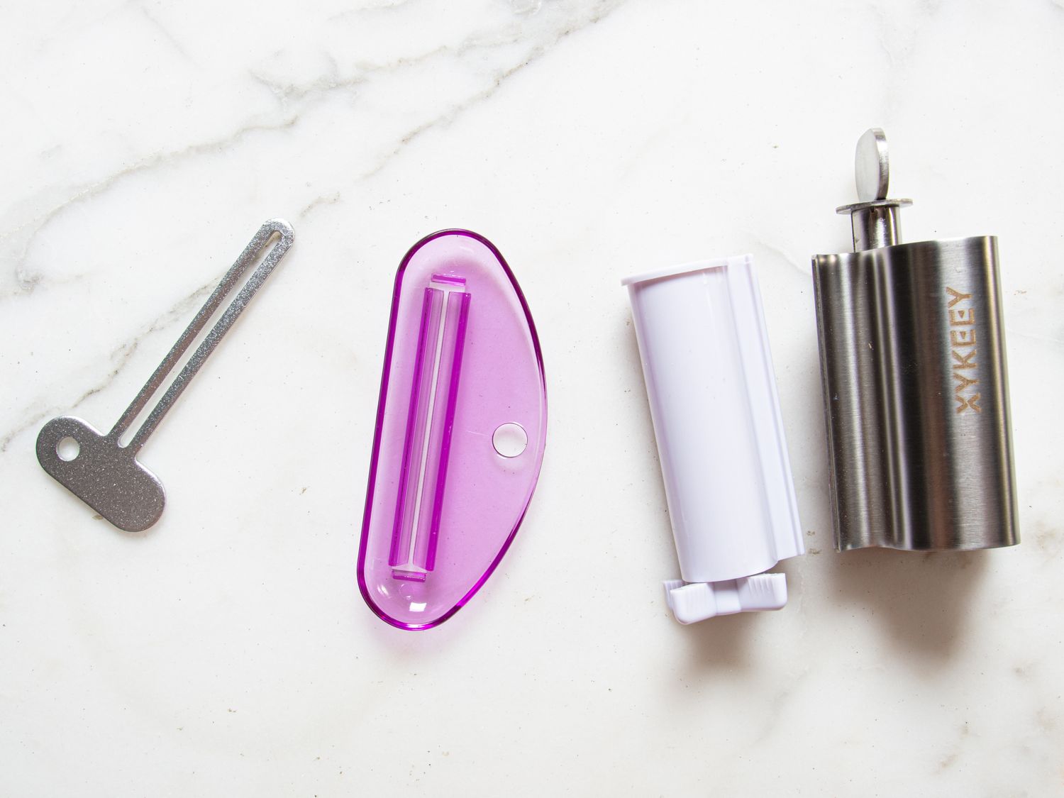 Various toothpaste tube squeezers displayed on a surface
